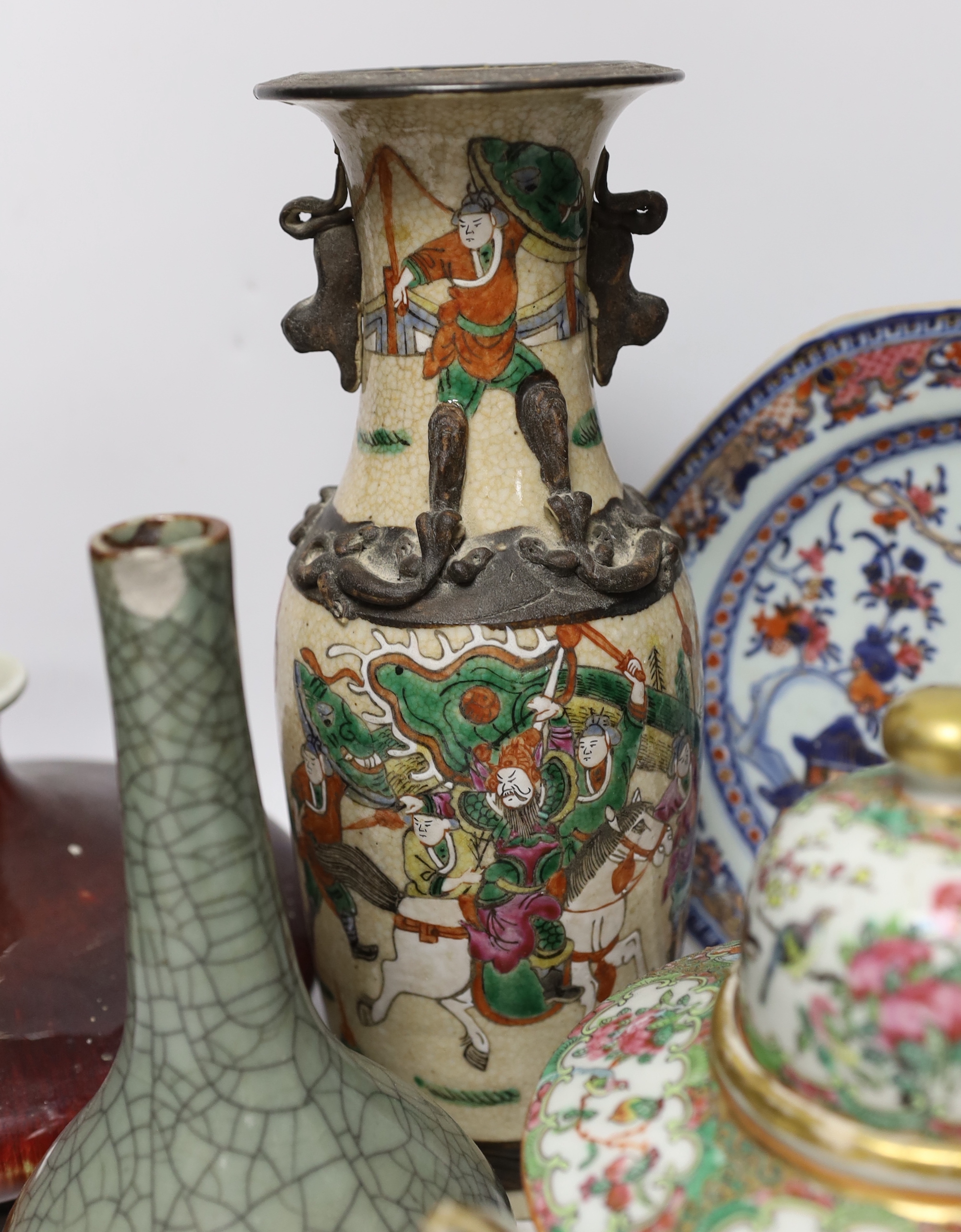 An 18th century Chinese export dish, a sang de boeuf squat vase, a crackle glaze bottle vase and a famille rose teapot, tallest 23cm